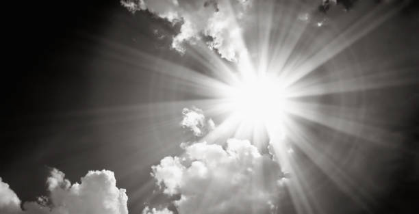 istock Black and white dramatic cloudy sky with shinning sun 2153519078