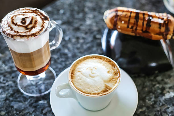 istock Cup of Cappuccino and Hot Dog on Table 2153520643