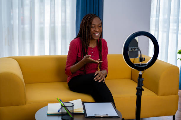 istock Smiling young African female influencer doing a vlog post at home 2153522544