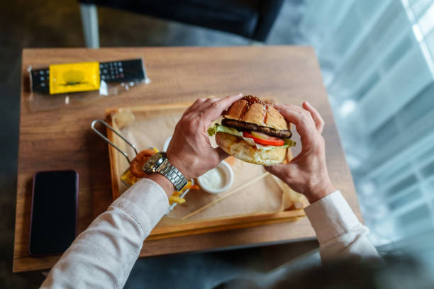 istock Man is eating burger in hotel room. 2153523097
