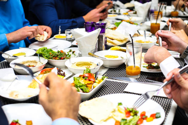 istock Group of People Enjoying a Meal Together at a Table 2153523148