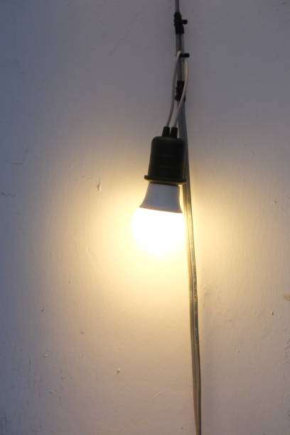 istock Electric light bulbs hung along the wall. 2153524120