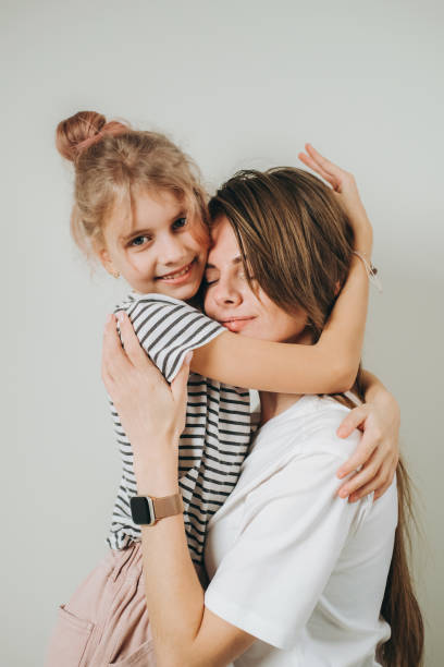 istock Beautiful mother and her cute daughter hugging 2153527049