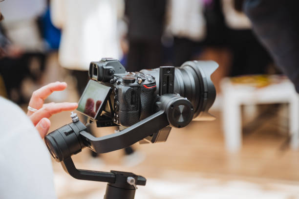 Person with camera on gimbal capturing event footage