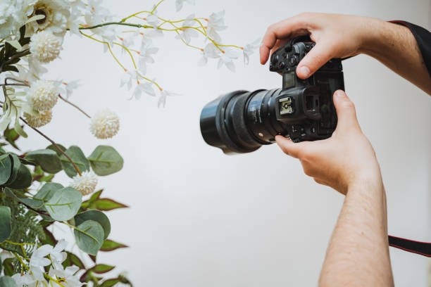 istock Photographer capturing flowers with digital camera and camera lens 2153531822
