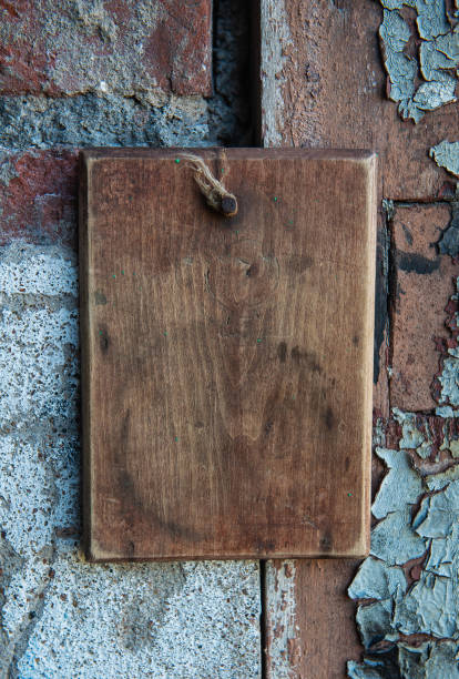 istock Old wooden blank signboard on the aged cement wall background 2153533495
