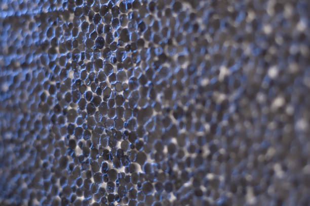 Texture of the green synthetic material of the soft kitchen cleaning sponge, top view close-up