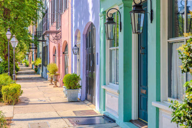 Charleston, South Carolina - May 7, 2024:  The famous Rainbow Row in Charleston, with a long cluster of Georgian row houses with pastel colors on the East Bay Street.  HDR encoded.