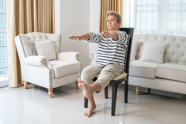 istock Elderly Woman Doing Chair Exercises at Home. 2153538251