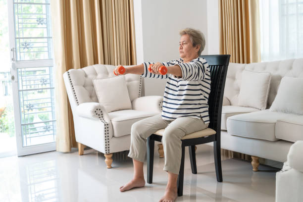 istock Elderly Woman Lifting Dumbbells for Exercise at Home. 2153538294