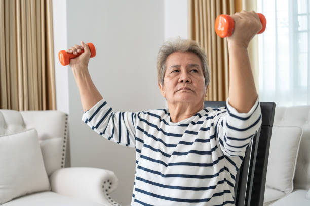 istock Elderly Woman Lifting Dumbbells for Exercise at Home. 2153538296