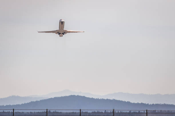 Passenger airplane just departed from Ljubljana airport retracting the landing gear. Photo taken outside of the airport area.