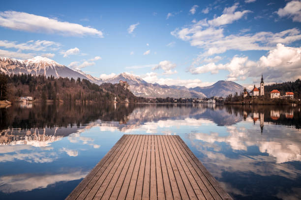 A view from the wooden pier towards the famous island with a church on the Lake Bled, Slovenia