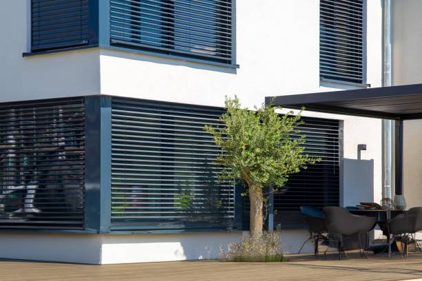 istock Modern blinds on a sliding window with access to the garden terrace 2153540239