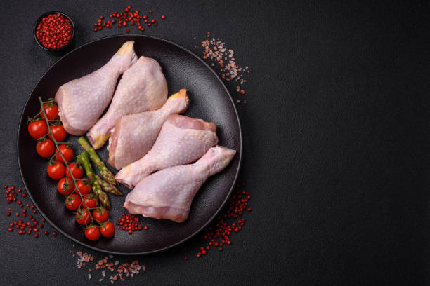 istock Raw chicken legs with salt, spices and herbs 2153541834