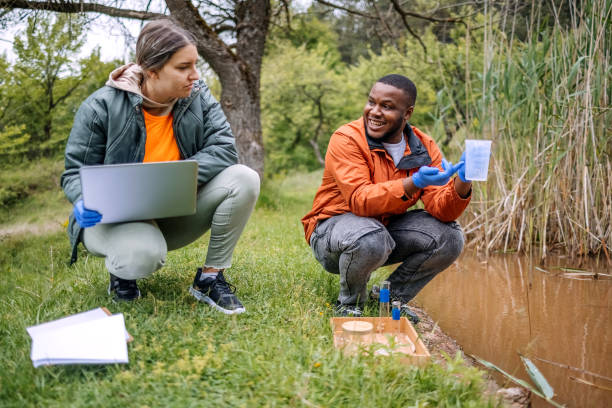 istock Young scientists doing research in nature taking a water sample from a lake 2153542494