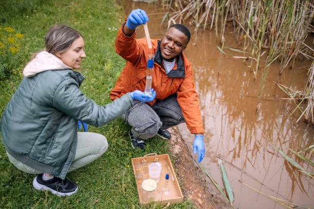 istock Young scientists doing research in nature taking a water sample from a lake 2153542497