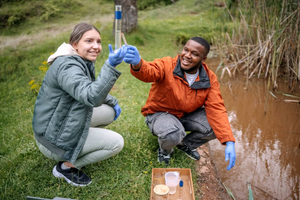 istock Young scientists doing research in nature taking a water sample from a lake 2153542511
