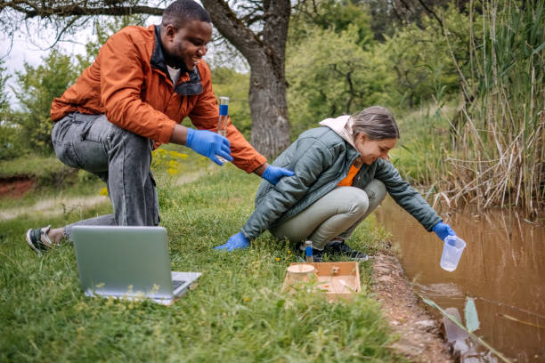 istock Young scientists doing research in nature taking a water sample from a lake 2153542512