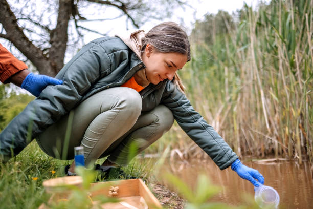 istock Young scientists doing research in nature taking a water sample from a lake 2153542521