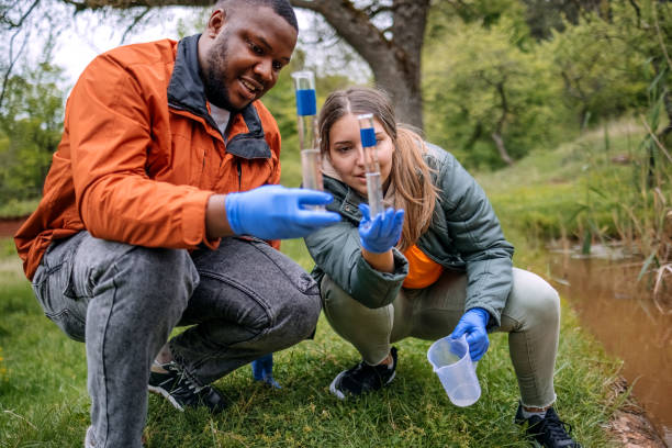 istock Young scientists doing research in nature taking a water sample from a lake 2153542532
