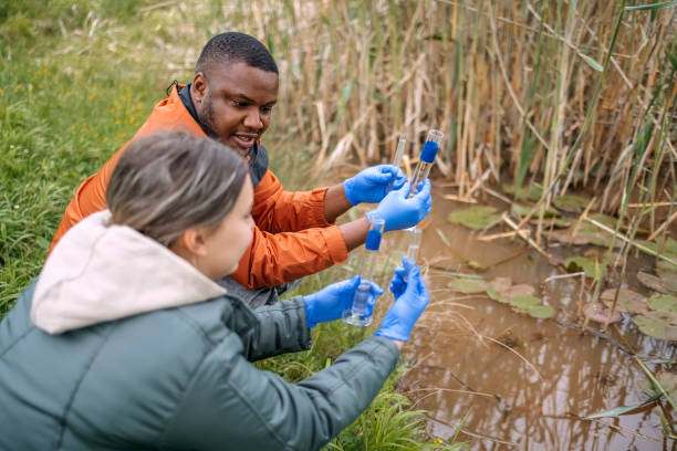 istock Young scientists doing research in nature taking a water sample from a lake 2153542554