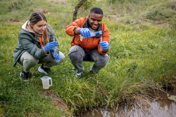 istock Young scientists doing research in nature taking a water sample from a lake 2153542562