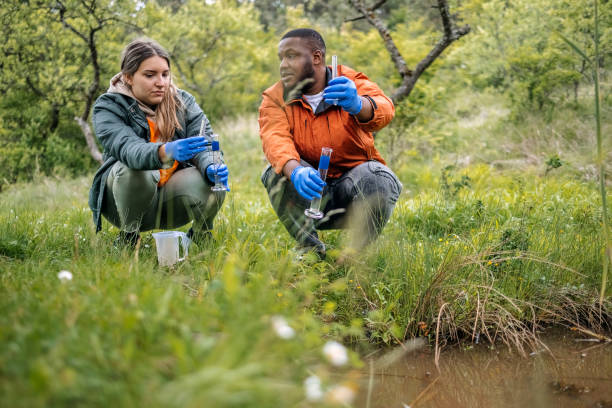 istock Young scientists doing research in nature taking a water sample from a lake 2153542564