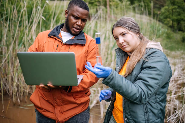istock Young scientists doing research in nature taking a water sample from a lake 2153542571