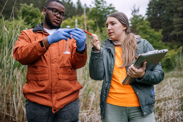 istock Young scientists doing research in nature taking a water sample from a lake 2153542575