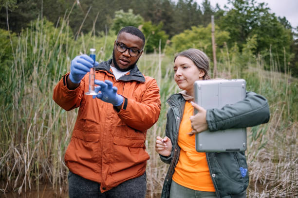 istock Young scientists doing research in nature taking a water sample from a lake 2153542594