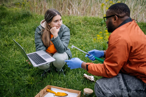 istock Young scientists doing research in nature taking a plant sample 2153542602