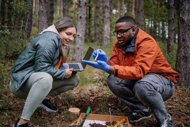 istock Young scientists doing research in nature taking a plant sample 2153542622