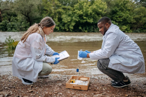 istock Young scientists doing research in nature taking sample of water from a river 2153542670