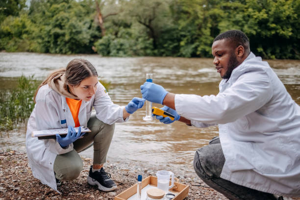 istock Young scientists doing research in nature taking sample of water from a river 2153542690