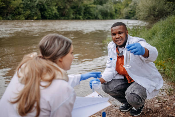 istock Young scientists doing research in nature taking sample of water from a river 2153542696