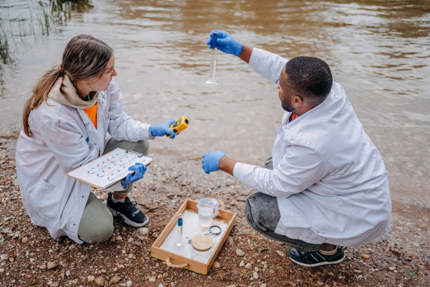 istock Young scientists doing research in nature taking sample of water from a river 2153542697