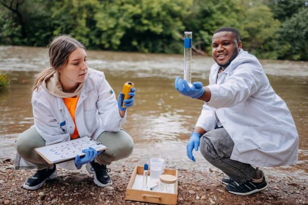 istock Young scientists doing research in nature taking sample of water from a river 2153542717