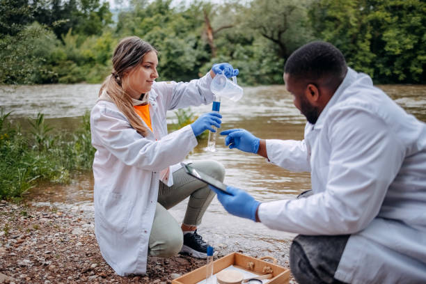 istock Young scientists doing research in nature taking sample of water from a river 2153542730