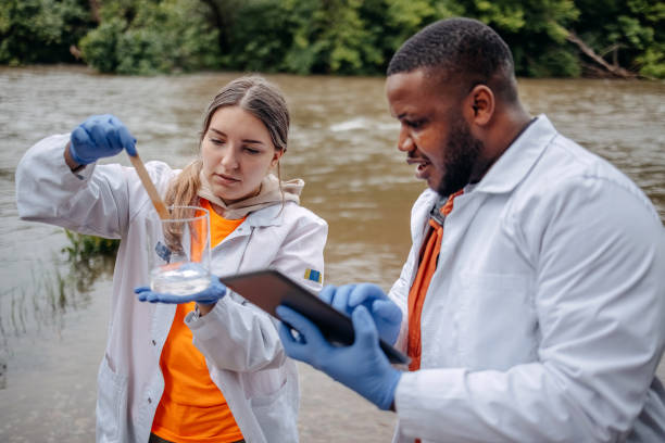 istock Young scientists doing research in nature taking sample of water from a river 2153542737