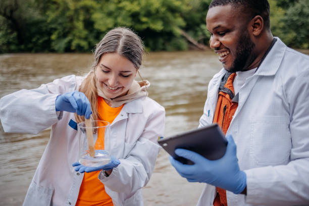istock Young scientists doing research in nature taking sample of water from a river 2153542769