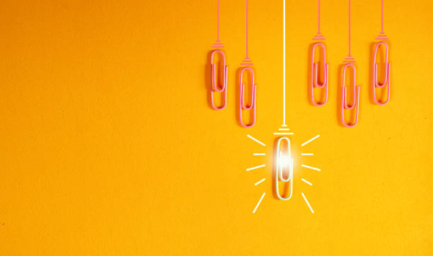 istock innovation concept with paperclip,thinking,creativity,light bulb on orange background,business and society concept. 2153543631