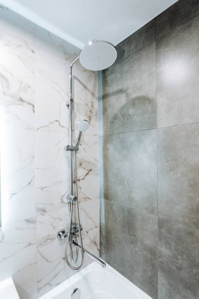 istock A bathroom with a shower, bathtub, tile flooring, and glass enclosure 2153543736