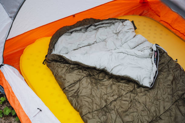 istock A sleeping bag rests on a yellow mattress inside a tent 2153543786