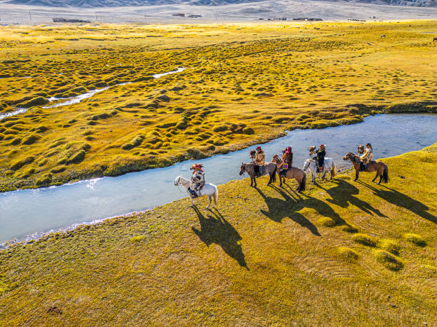 group of Kazakh eagle hunters riding horses in Bayan Olgii, West Mongolia