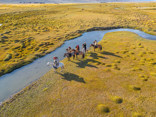 istock group of Kazakh eagle hunters riding horses in Bayan Olgii, West Mongolia 2153544405