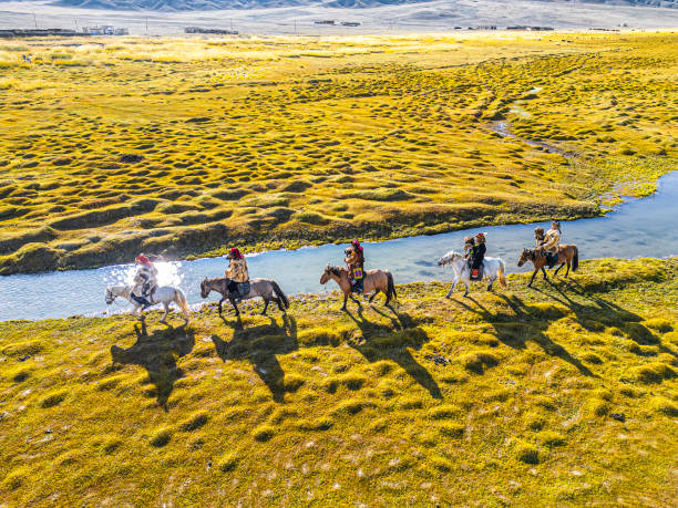 istock group of Kazakh eagle hunters riding horses along river Bayan Olgii, West Mongolia 2153544410