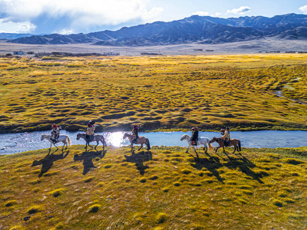istock group of Kazakh eagle hunters riding horses along river Bayan Olgii, West Mongolia 2153544416