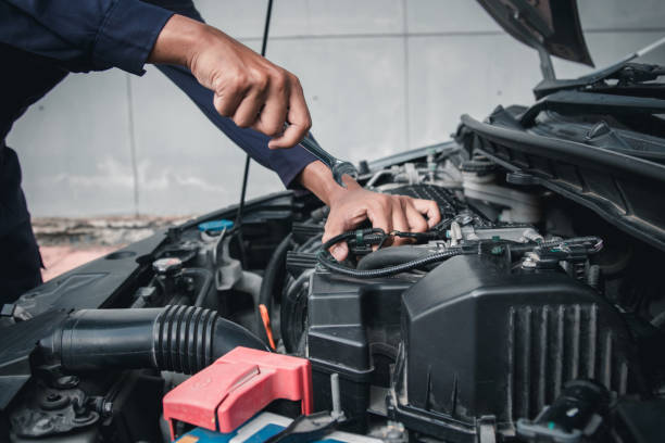 istock Mechanic using wrench while working on car engine outside the service center , Repair and service. 2153545200
