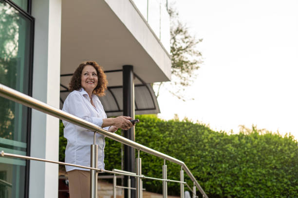 istock Mature woman using cell phone at home. 2153545244